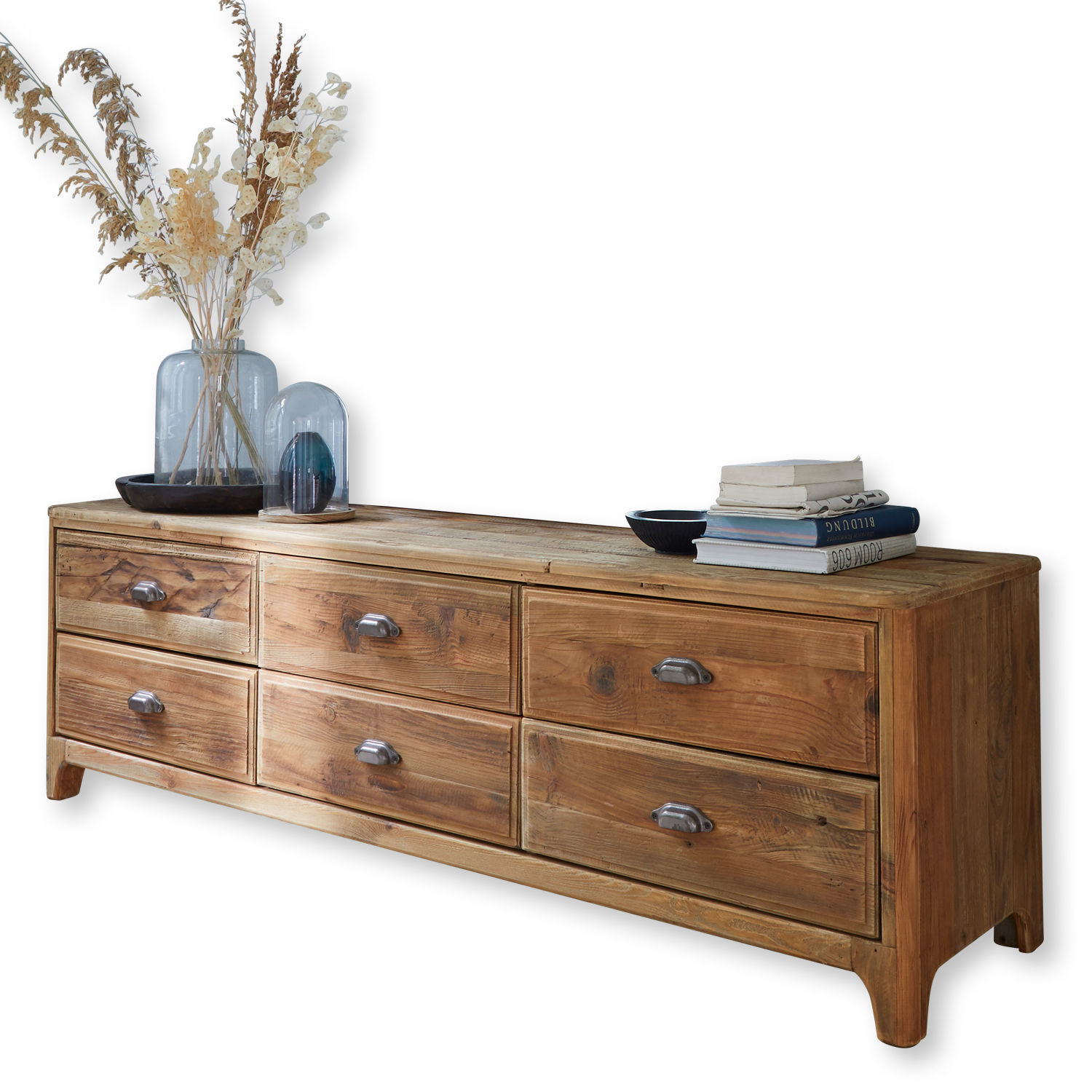Cómoda Wittfield Cómoda de madera natural con seis cajones y tiradores metálicos, decorada con libros y jarrones