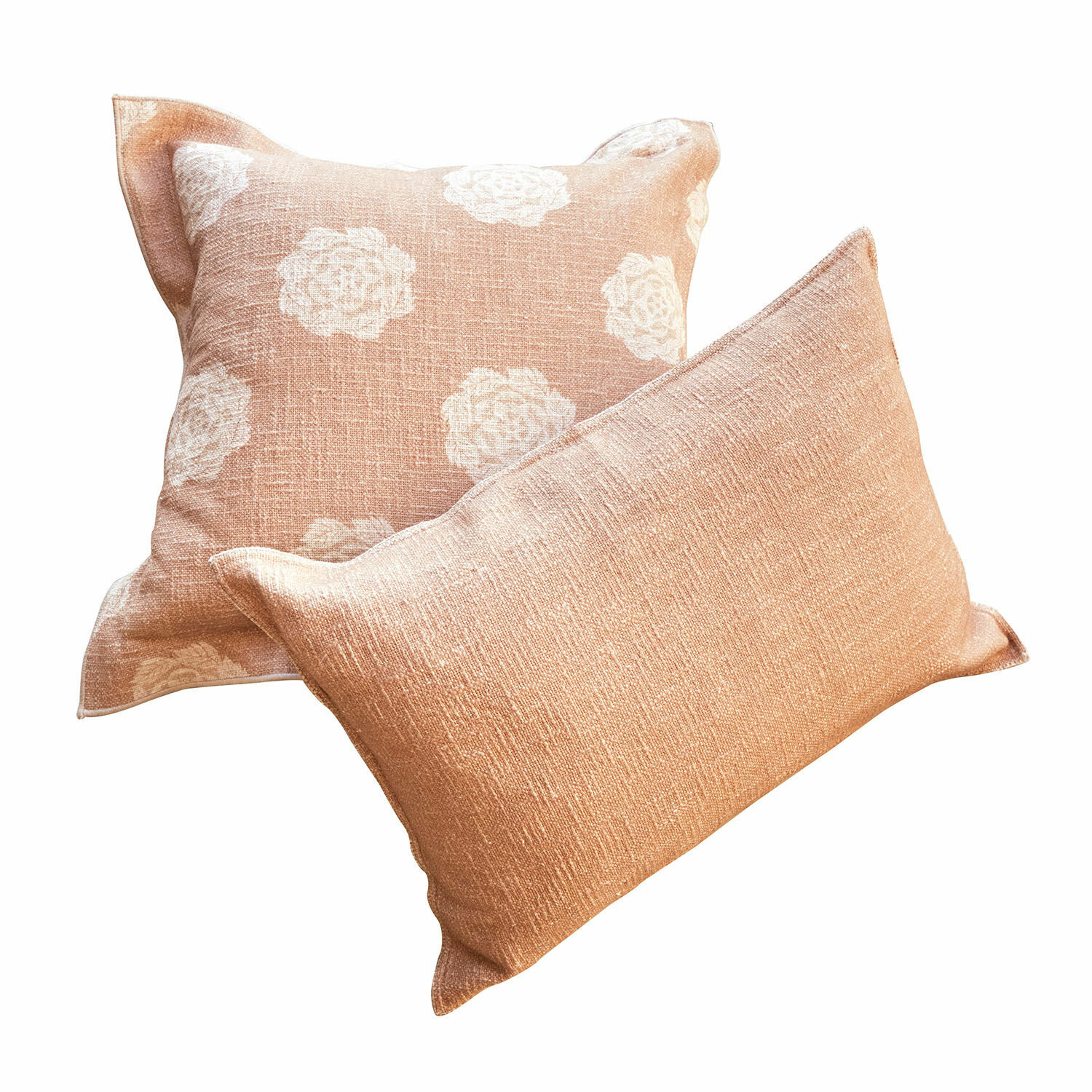Conjunto de dos cojines decorativos de tela color melocotón con diseño floral blanco