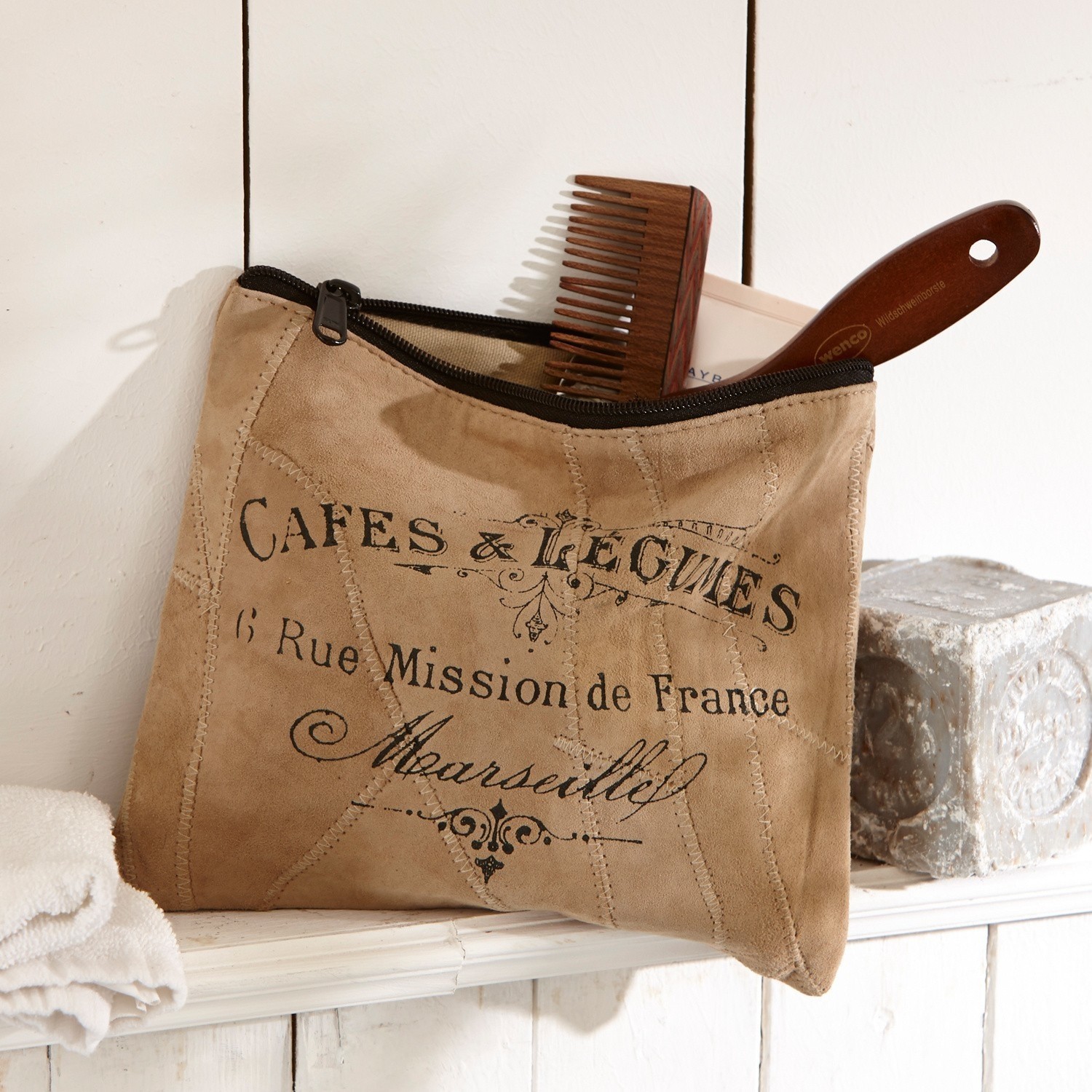 Bolsa pequeña Jeannice Neceser beige de ante con cremallera negra y estampado francés, peine de madera visible en estante