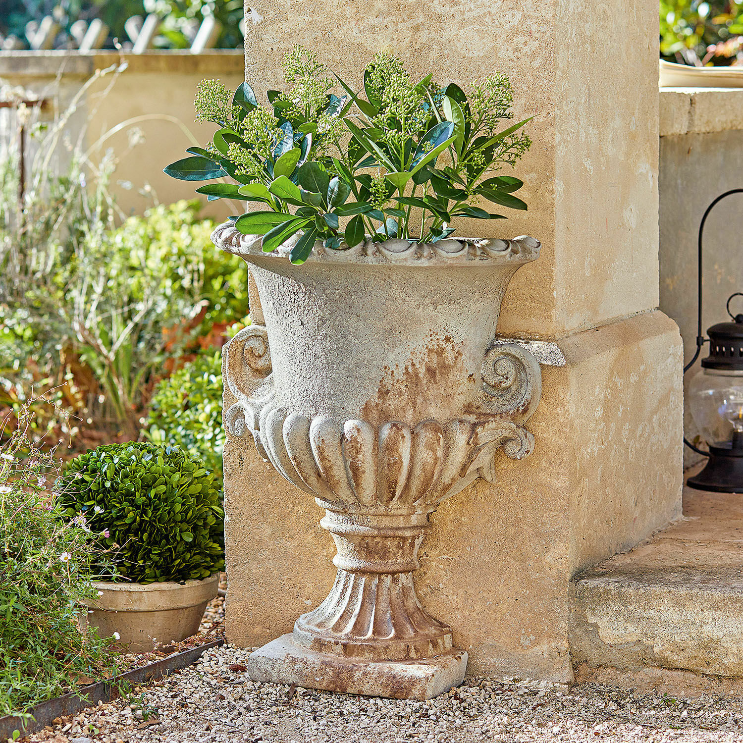Ánfora Cevio Maceta decorativa de piedra beige con plantas verdes para jardín exterior