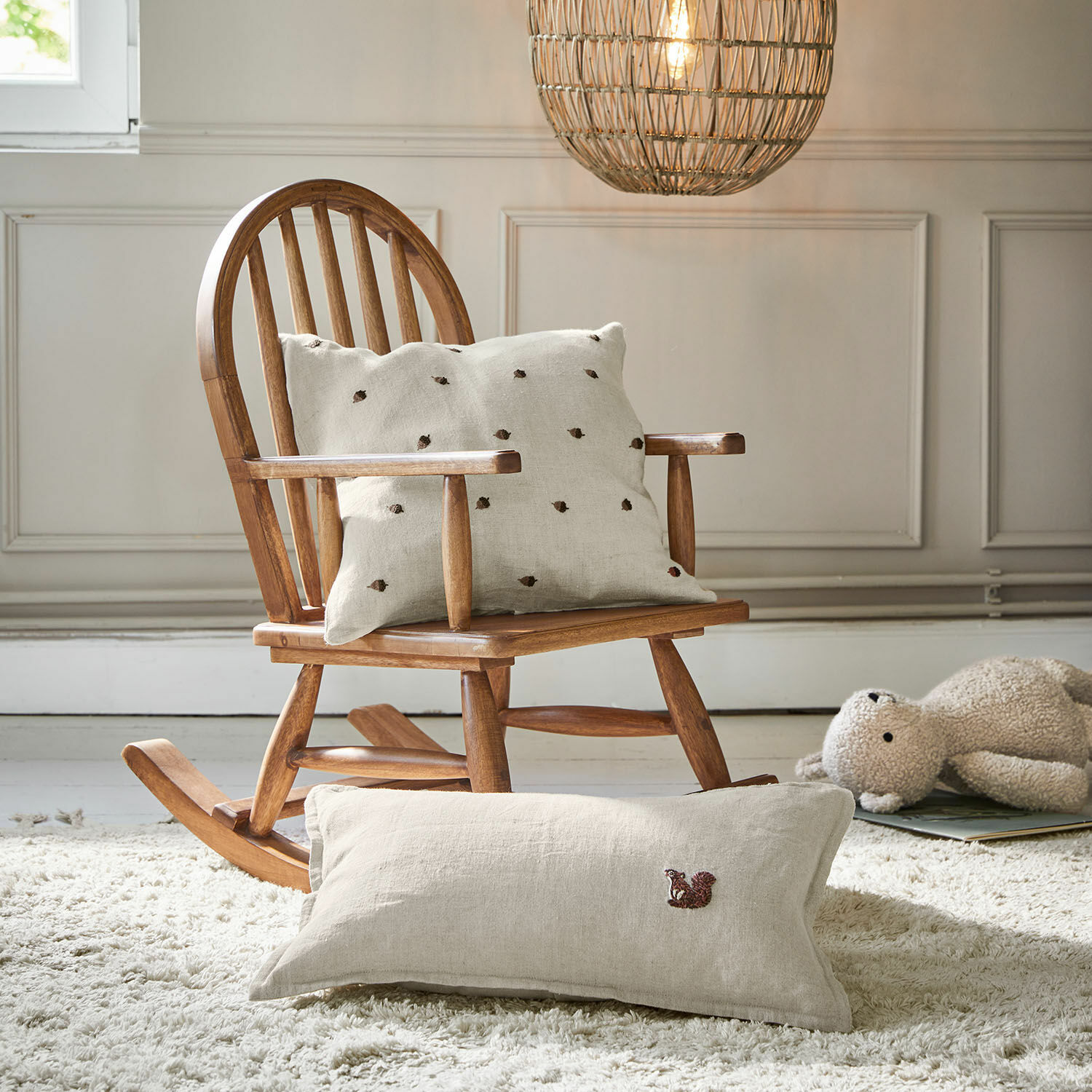 Mecedora infantil Brenali Mecedora de madera con cojín de lino beige claro bordado, ambiente acogedor en habitación infantil