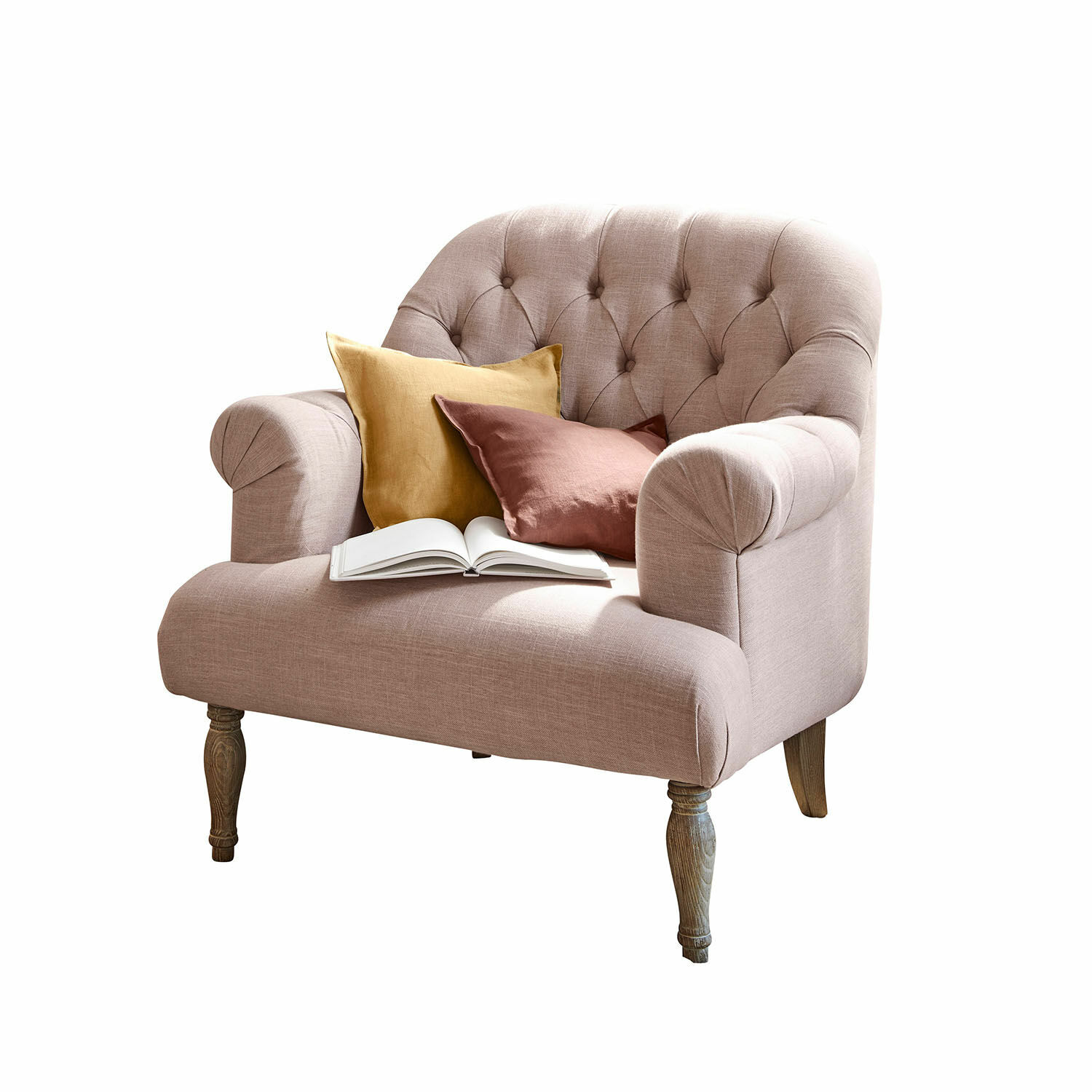 Sillón Shambrook Sofá tapizado rosa con patas de madera, decorado con dos cojines y un libro abierto