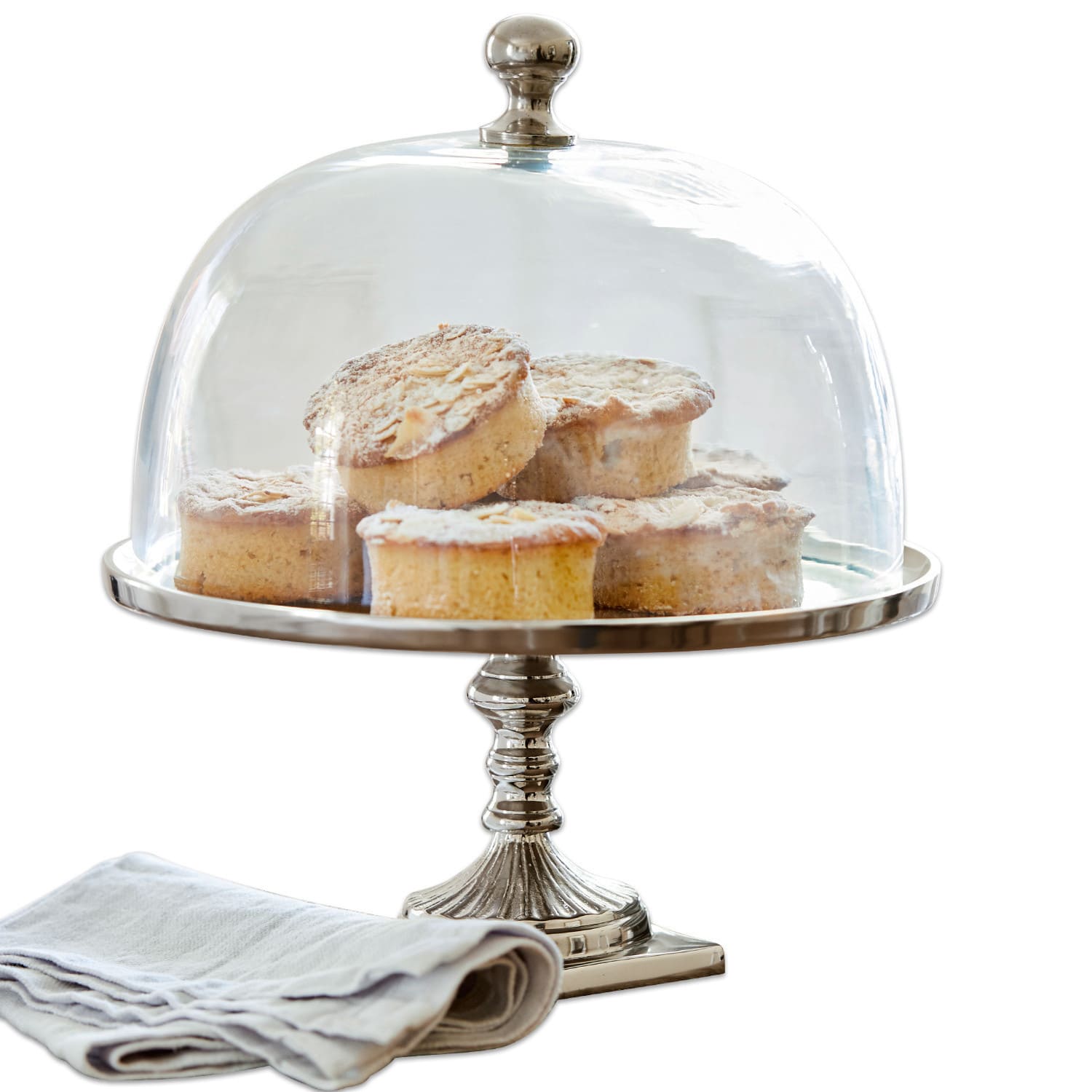 Campana de cristal con plato Mine Soporte para pasteles plateado con campana transparente, con pasteles y servilleta de lino