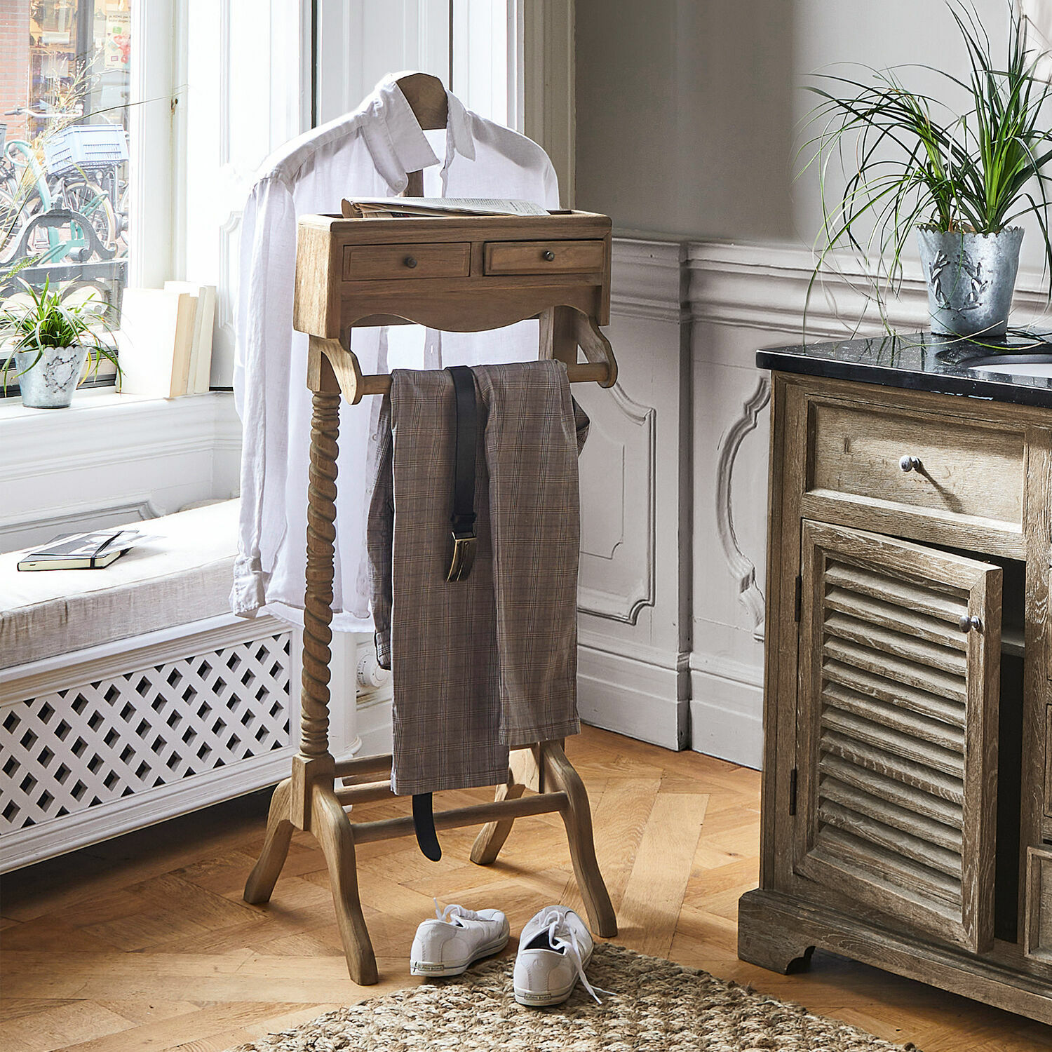 Galán de noche Doncaster Perchero de madera con cajones y soporte para pantalones en habitación luminosa con suelo de madera
