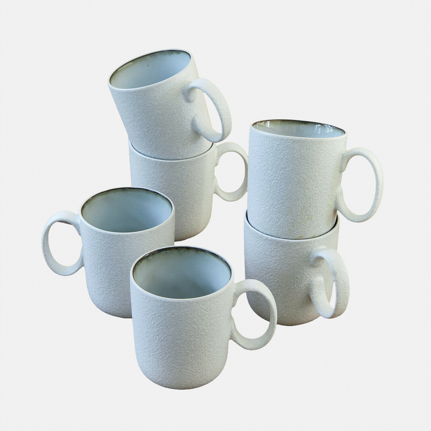 Set de 6 tazas Eiruna Conjunto de seis tazas de cerámica blanca con textura rugosa y interior gris para café y té