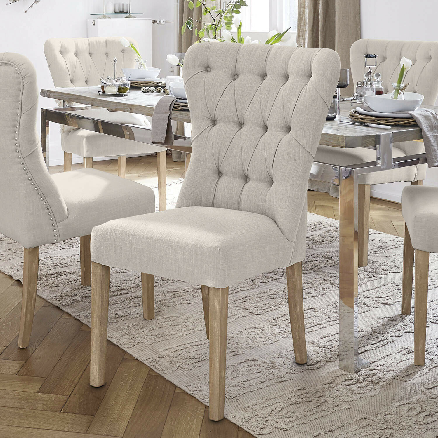 Sillas tapizadas beige con patas de madera junto a mesa de madera clara en comedor