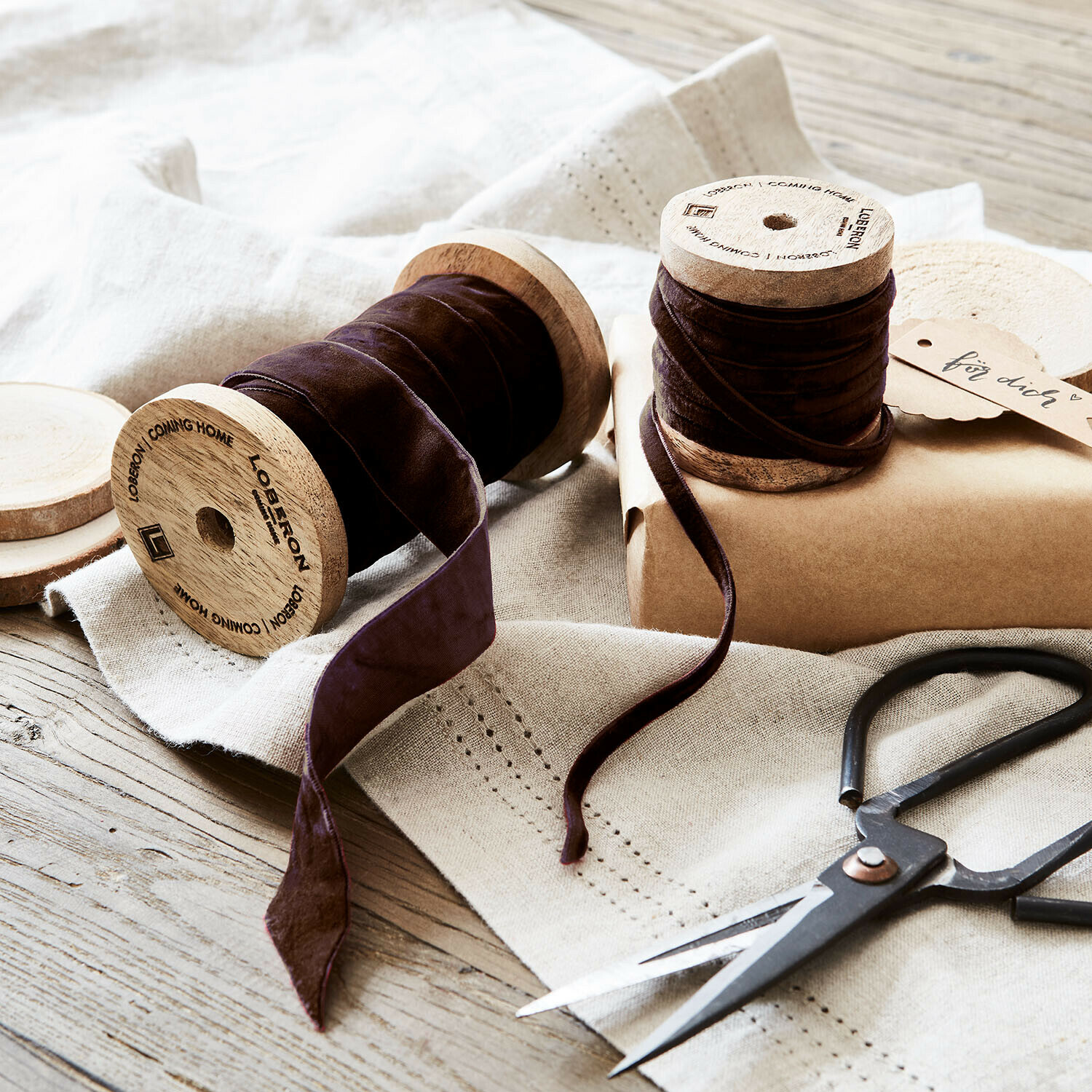 Set de 2 cintas de terciopelo Liandis Cinta de terciopelo marrón en carretes de madera con tijeras sobre mantel de lino, decoración DIY
