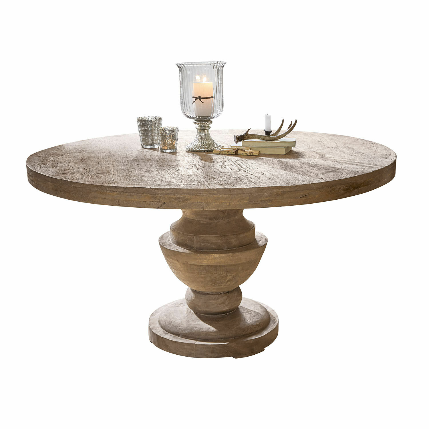 Mesa Retonfey Mesa redonda de madera maciza en color natural con velas decorativas y libros sobre la superficie