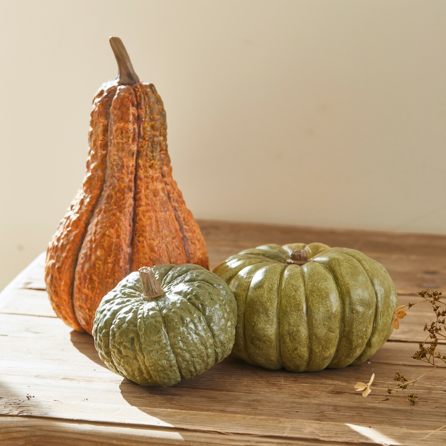 Set de 3 calabazas Raliven Calabazas decorativas verdes y naranjas sobre mesa de madera, decoración otoñal