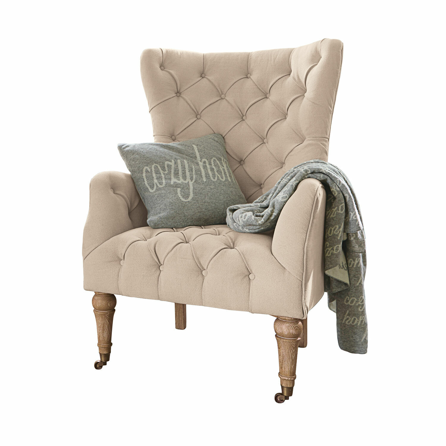 Sillón Migré Sillón beige tapizado con patas de madera, cojín y manta gris cozy home para sala