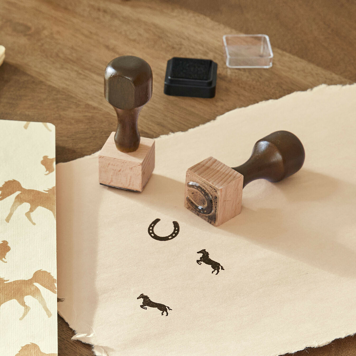 Sellos de madera con motivos de caballo y herradura sobre papel beige para manualidades
