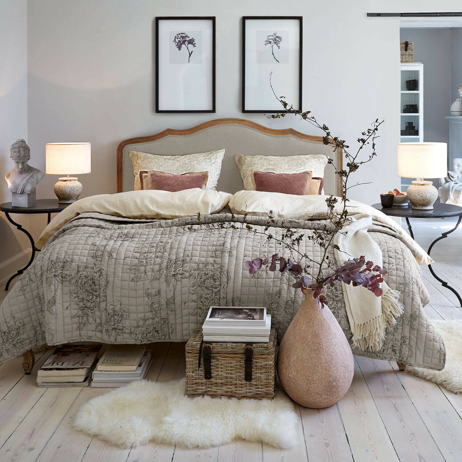 Cama Serravalle Dormitorio acogedor con cama en ropa de cama beige y colcha acolchada decorativa con diseño floral