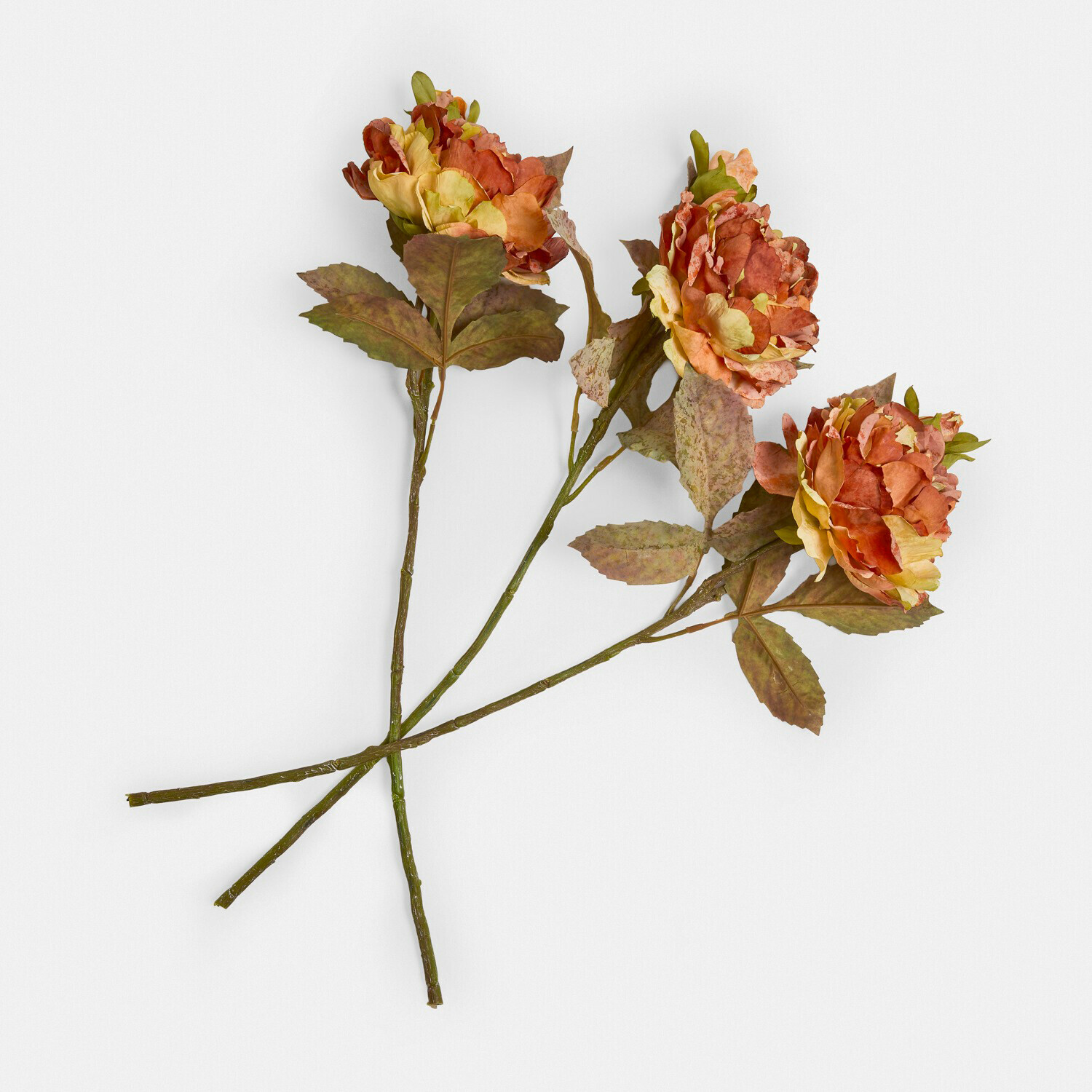 Set de 3 flores decorativas Ambrayelle Tres flores artificiales en tonos naranja y amarillo con hojas verdes sobre fondo blanco