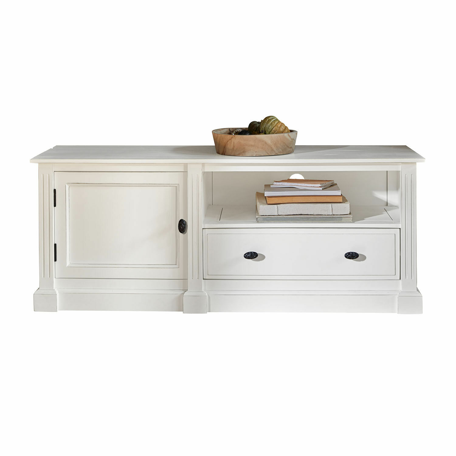 Mesa baja blanca de madera con cajón y estante, cuenco decorativo y libros encima