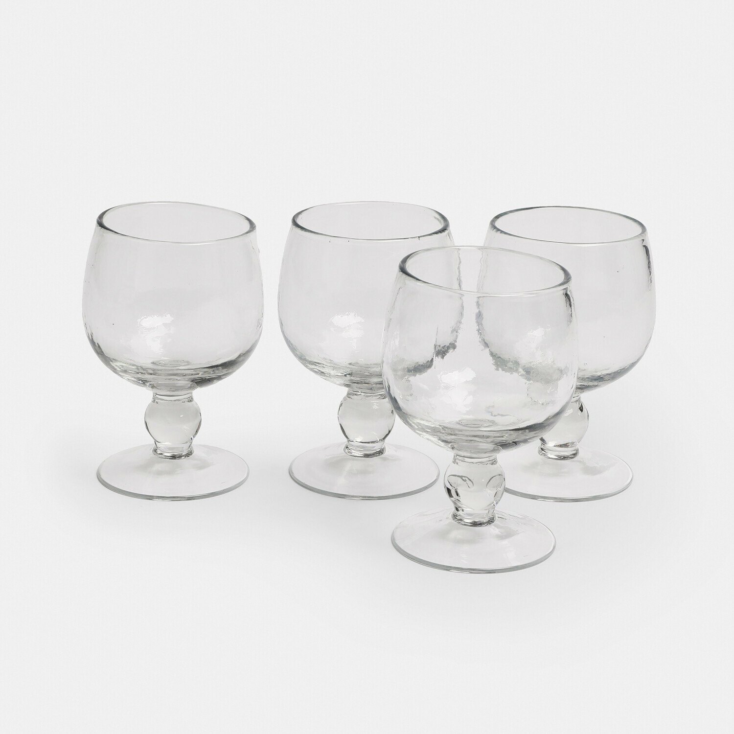 Conjunto de cuatro vasos transparentes de vidrio con pie para bebidas alcohólicas